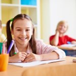 girl-with-a-big-smile-in-a-classroom_1098-303