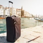 small-suitcase-on-travel-urban-background-venice-italy-horizontal-toning-travel-vacation-concept_1220-1302